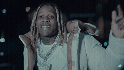 A Man Wearing A Jacket And A Necklace With A Pendant That Says ' Grungy ' On It GIF
