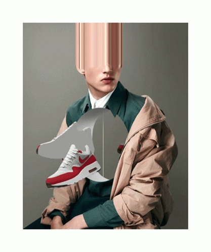 A Man Wearing A Jacket Is Holding A Pair Of Nike Shoes GIF
