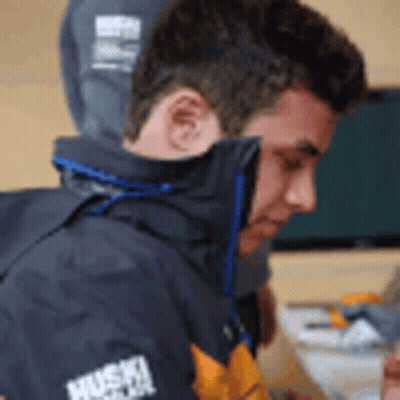 A Man Wearing A Jacket That Says Husky On The Sleeves GIF