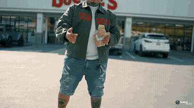 A Man Wearing A Jacket That Says " That 'S A Lot Of Money " On It GIF