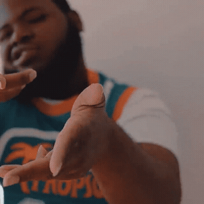 A Man Wearing A Jersey That Says Miami GIF
