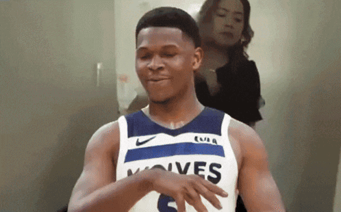 A Man Wearing A Jersey That Says Wolves Is Dancing GIF