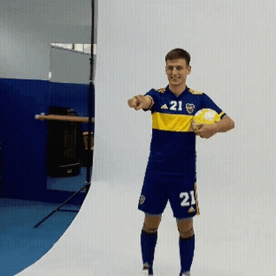 A Man Wearing A Jersey With The Number 21 On It Holds A Soccer Ball GIF
