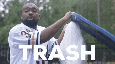 A Man Wearing A Jersey With The Number 34 On It Is Holding A Trash Can GIF