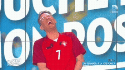 A Man Wearing A Jersey With The Number 7 On It Laughs GIF
