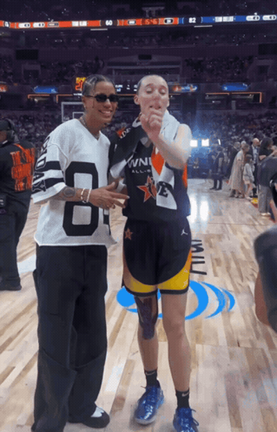A Man Wearing A Jersey With The Number 8 On It Stands Next To Another Man GIF