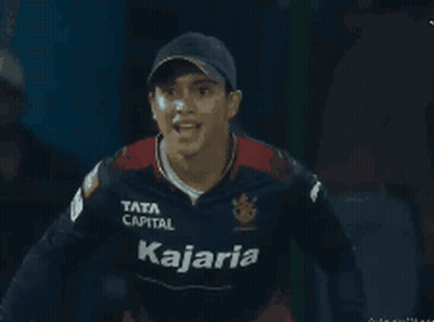 A Man Wearing A Kajaria Jersey Holds Up His Arms GIF
