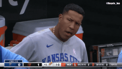 A Man Wearing A Kansas City Jersey Stands In A Dugout GIF
