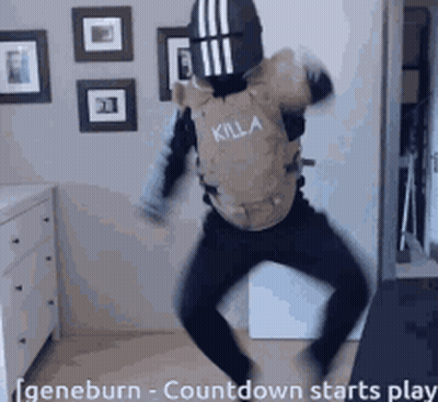 A Man Wearing A Killa Vest Is Dancing In A Room GIF