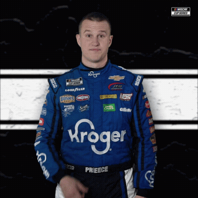 A Man Wearing A Kroger Racing Suit Looks At The Camera GIF