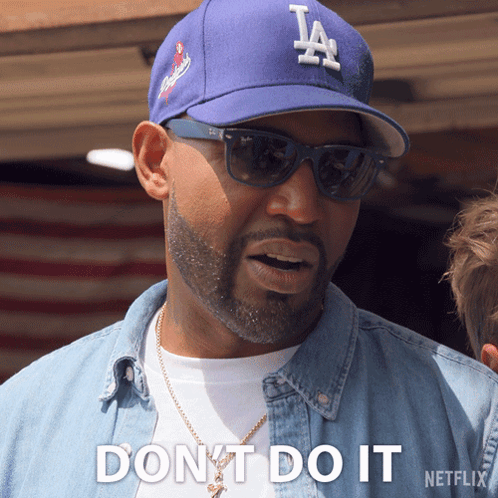 A Man Wearing A La Hat And Sunglasses Says " Dont Do It " GIF