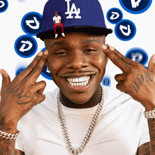A Man Wearing A La Hat Holds His Hands To His Face GIF