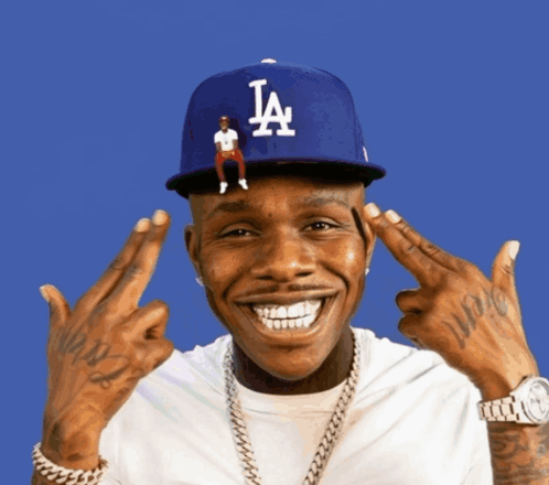 A Man Wearing A La Hat Is Making A Funny Face GIF