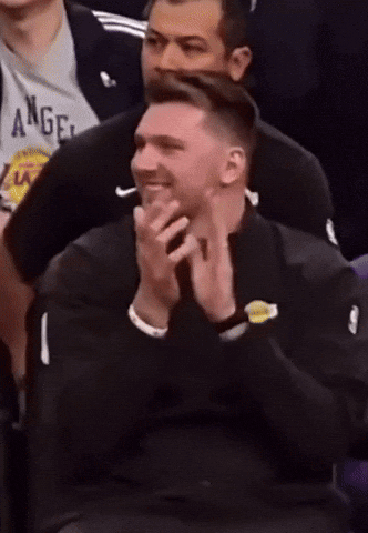 A Man Wearing A Lakers Jacket Is Clapping GIF