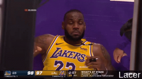 A Man Wearing A Lakers Jersey Looks At Something GIF