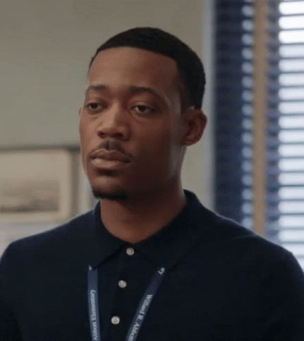 A Man Wearing A Lanyard That Says Community Recovery On It GIF
