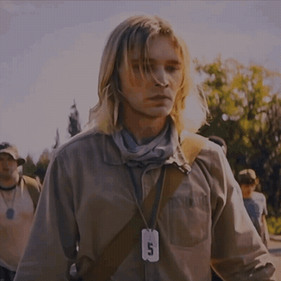 A Man Wearing A Lanyard With A Tag That Says 5 On It GIF