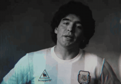 A Man Wearing A Le Coq Sportif Shirt Is Looking At The Camera GIF