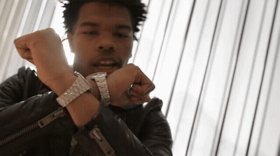A Man Wearing A Leather Jacket And A Silver Watch On His Wrist GIF