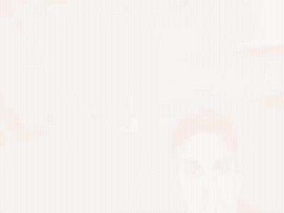 A Man Wearing A Leather Jacket Is Covering His Mouth GIF