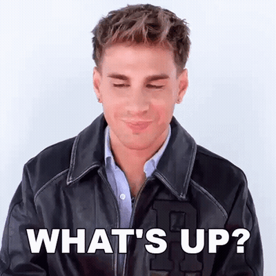 A Man Wearing A Leather Jacket Is Making A Funny Face And Says What 'S Up ? GIF