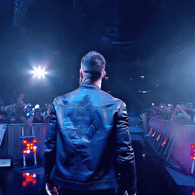 A Man Wearing A Leather Jacket With A X On The Back GIF