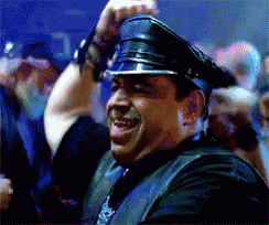 A Man Wearing A Leather Vest And A Police Hat GIF