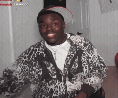 a man wearing a leopard print jacket and a hat with a key on it
