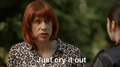 A Man Wearing A Leopard Print Shirt Is Talking To A Woman . GIF