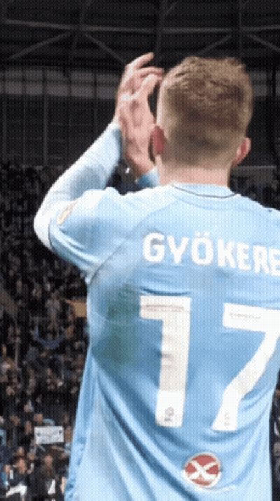 A Man Wearing A Light Blue Jersey With The Number 7 On The Back GIF