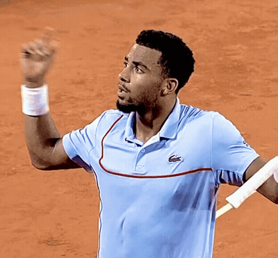 A Man Wearing A Light Blue Shirt With A Lacoste Logo On The Front GIF