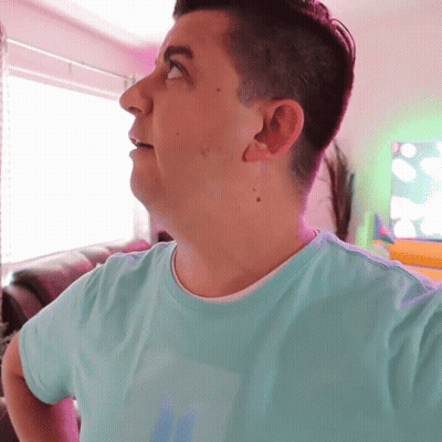 A Man Wearing A Light Blue Shirt With The Letter S On It GIF