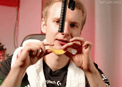 A Man Wearing A Logitech Shirt Is Holding A Chip In His Mouth GIF
