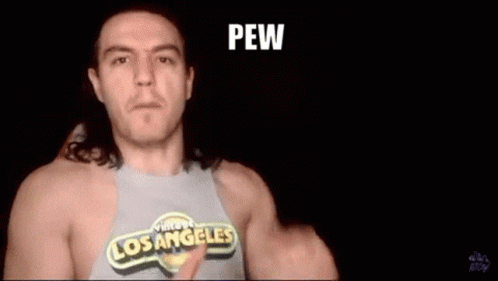 A Man Wearing A Los Angeles Shirt Is Pointing At The Camera And Says Shooting From The Hip . GIF