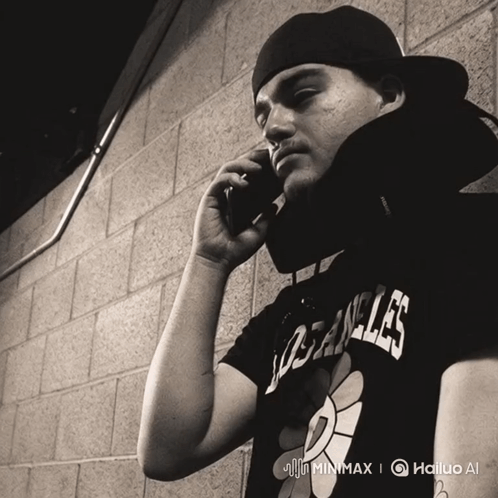 A Man Wearing A Los Angeles Shirt Is Talking On His Cell Phone GIF