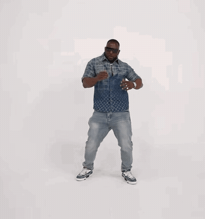 A Man Wearing A Louis Vuitton Shirt And Jeans Is Dancing GIF