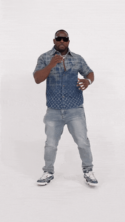 A Man Wearing A Louis Vuitton Shirt And Jeans Is Dancing GIF