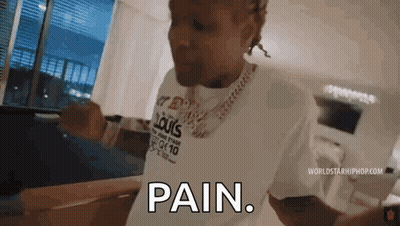 A Man Wearing A Louis Vuitton Shirt Is Standing In A Living Room And Says `` Pain '' . GIF