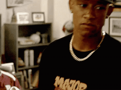 A Man Wearing A Major Shirt And A Gold Chain Around His Neck GIF