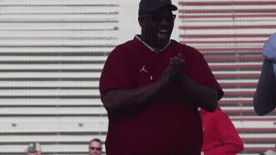 A Man Wearing A Maroon Shirt With The Letters J On It GIF