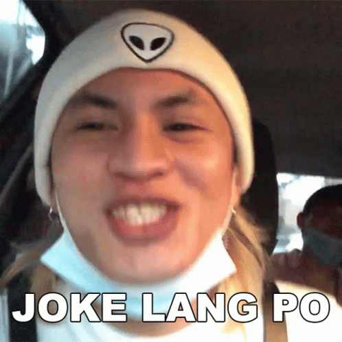 A Man Wearing A Mask And A Beanie Is Making A Funny Face And Says Joke Lang Po GIF
