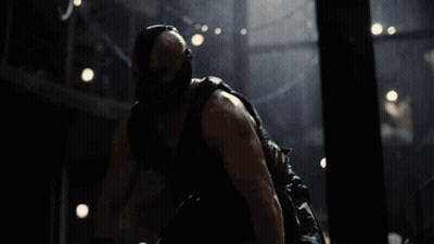 A Man Wearing A Mask And Gloves Is Laying On The Ground In A Dark Room GIF