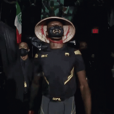 A Man Wearing A Mask And Gloves With The Word Ufc On His Belt GIF