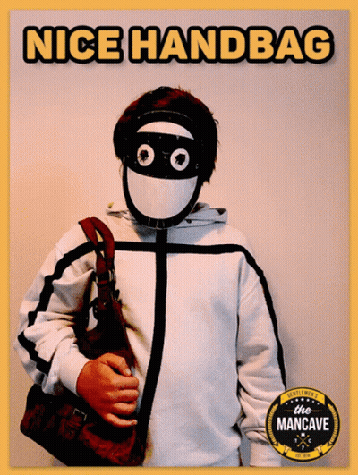A Man Wearing A Mask And Holding A Purse With The Words Nice Handbag Written Above Him GIF
