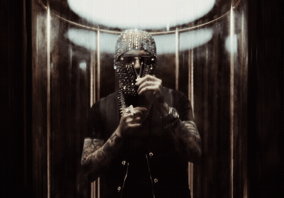 A Man Wearing A Mask And Sunglasses Is Standing In Front Of A Mirror GIF