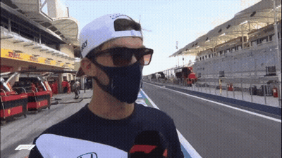 A Man Wearing A Mask And Sunglasses Is Standing On A Track GIF