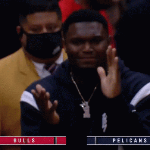A Man Wearing A Mask Applauds During A Bulls Vs Pelicans Game GIF