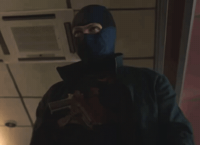 A Man Wearing A Mask Holds A Gun GIF