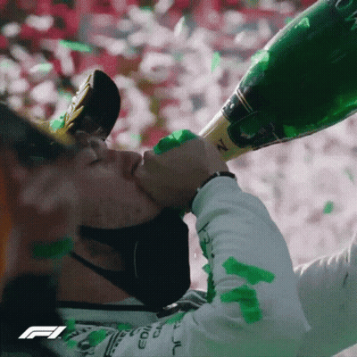 A Man Wearing A Mask Is Drinking From A Bottle Of Champagne GIF