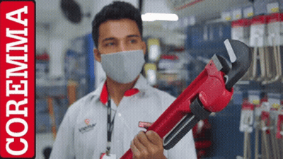 A Man Wearing A Mask Is Holding A Red Wrench In Front Of A Coremma Logo GIF